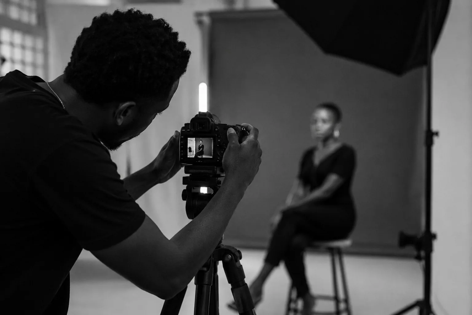 Photographer working with a portrait subject in studio